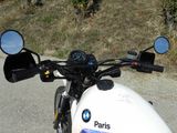 a white motorcycle parked on the side of the road