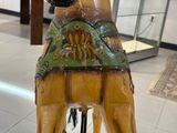 a statue of a giraffe with a hat on its head