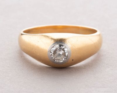 a close up of a gold ring with a diamond in the center