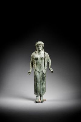 an image of a statue of a woman in a green dress