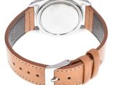 a close up of a watch on a white surface with a brown strap