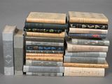 several books stacked on top of each other on a gray surface