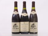 three bottles of wine sitting on top of a table next to each other