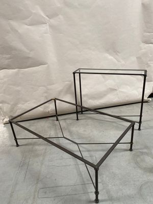 pair of iron and glass coffee tables in the shape of a hexagon