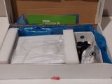 a box with a wii controller in it sitting on a table