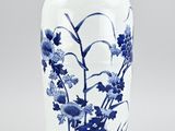 a blue and white vase sitting on a table