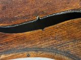 a piece of wood that has been cut off of the back of a violin