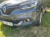 a grey car that is parked in the grass