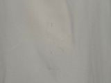 a close up of a white shirt with a hole in it