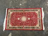 a red rug with a medallion design on it