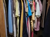 beaucoup de vêtements suspendus à un portant dans un placard