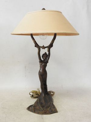a lamp that is sitting on a table with a lamp shade on it