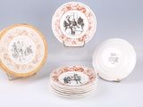 several plates with different designs and designs on them sitting on a table