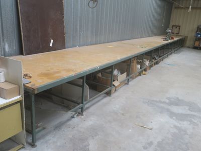 a long table with a sink in the middle of a room