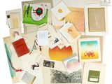 a pile of assorted cards and postcards on a white surface