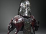 bronze statue of a man riding a horse with a hat on his head
