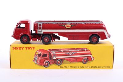a red toy truck that is on top of a box