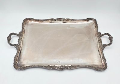 un plateau ancien en argent, muni de poignées, sur un fond blanc