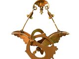 a metal bird hanging from a wire on a white background