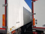 two trucks that are parked side by side in the parking lot