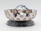 a white bowl with red and blue flowers on it