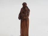 figurine of a woman holding a child on a wooden base