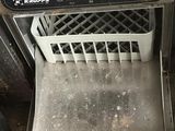 a dirty dishwasher sitting in the middle of a dirty kitchen