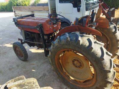 a tractor that is parked on the side of the road