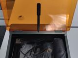 a yellow box with a black handle on top of a white table