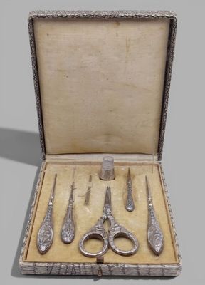 five pairs of scissors and a pair of scissors in a box