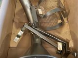 a box with a metal pipe and a metal strainer in it