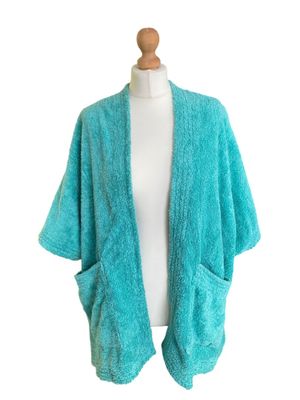 a close up of a mannequin torso wearing a blue cardigan