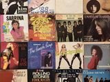 a lot of music covers on the wall of a room