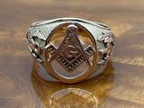a close up of a silver ring with a masonic symbol on it
