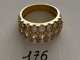 an image of a gold ring with a lot of diamonds on it