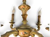 an image of a chandelier with three candles hanging from it