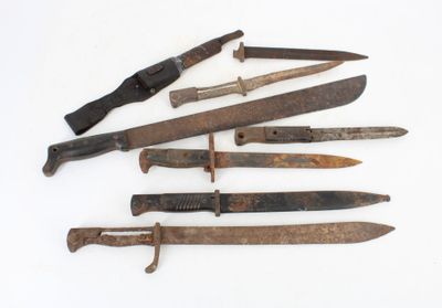 several different types of knives are displayed on a white surface