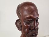 a statue of a man with a beard and a necklace