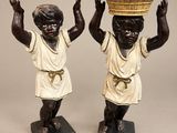 pair of bronze figurines of children carrying a basket on their heads