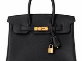 a black leather handbag with a lock on the handle