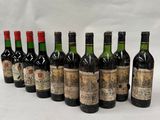 six bottles of wine lined up in a row on a white surface