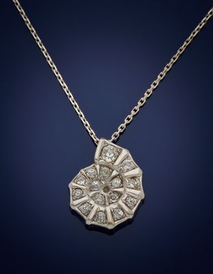 a white gold and diamond pendant on a chain