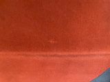 a close up of a red chair with a black seat