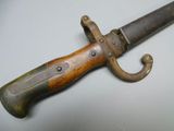 an old knife with a wooden handle on a white surface