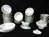 a lot of plates and bowls on a black table