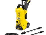 a yellow pressurer with a hose and a black hose