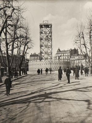 a black and white photo of people walking down the street