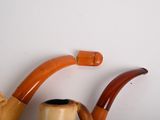 a pipe and a pipe holder sitting on a shelf