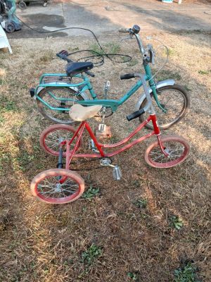 two bicycles that are parked in the grass