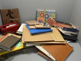 a pile of books on a table in a room